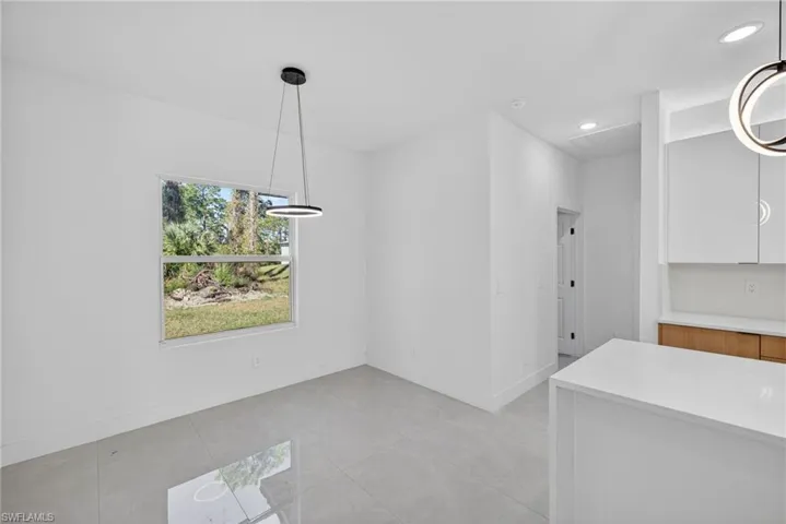 Unfurnished dining area with recessed lighting and light tile patterned floors