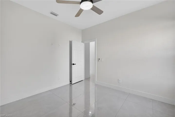 Unfurnished room featuring baseboards and ceiling fan