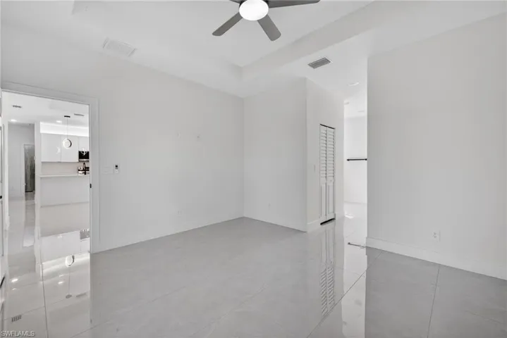 Unfurnished room with baseboards and ceiling fan