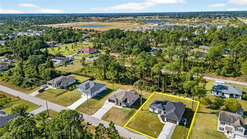 Aerial overview of property's location featuring nearby suburban area and property parcel outlined