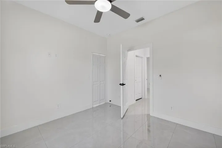 Unfurnished room with baseboards and ceiling fan