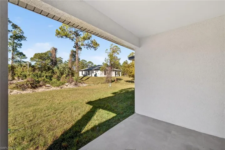 Covered lanai overlooking private backyard — home is complete and CO issued.