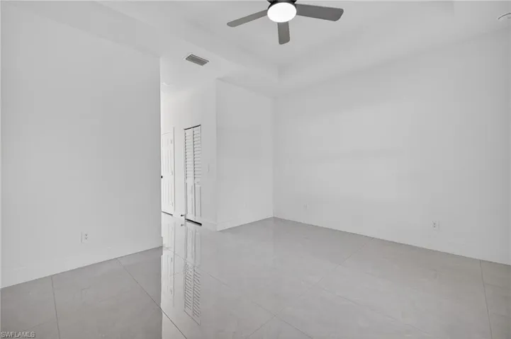 Empty room with baseboards and ceiling fan