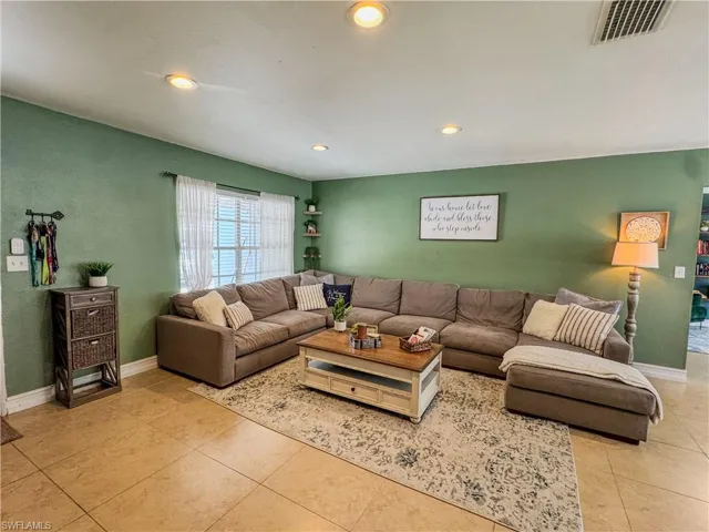 Living area featuring light tile patterned floors, recessed lighting, and baseboards
