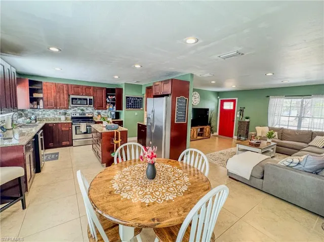 Dining area featuring light tile patterned floors and recessed lighting