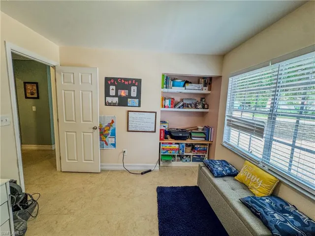Rec room with baseboards and tile patterned floors