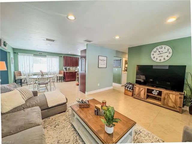 Living area with baseboards, recessed lighting, and light tile patterned floors