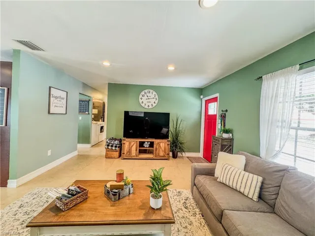 Living room with baseboards, recessed lighting, and light tile patterned floors