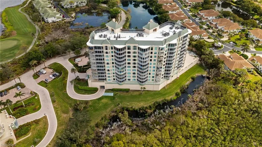 Birds eye view of property with a water view