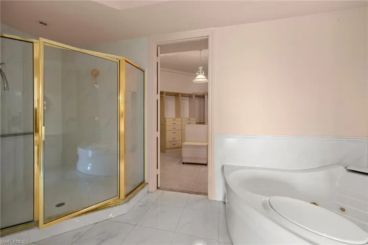 Bathroom featuring double vanity, soaking tub and large walk in shower