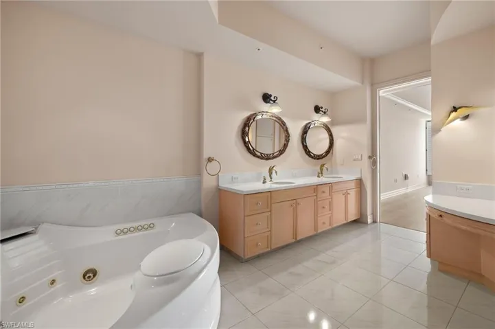 Full bathroom featuring a jetted tub and a shower stall