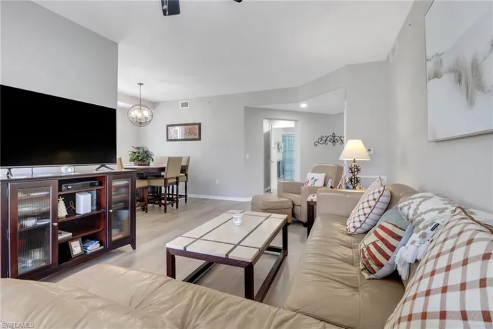 Living area featuring light wood finished floors and a chandelier