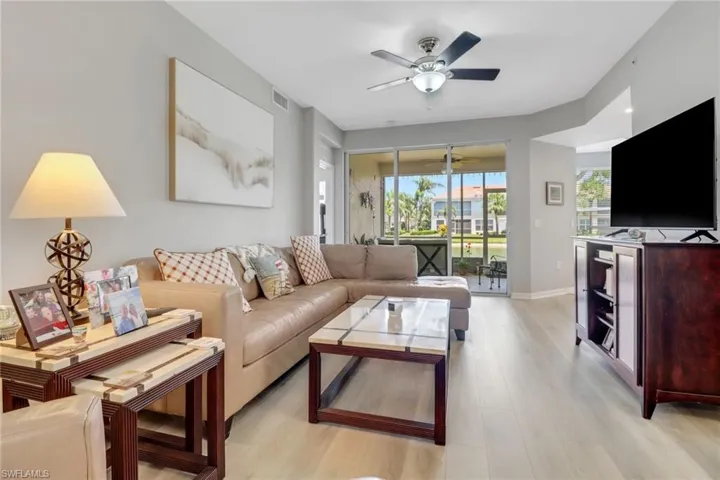 Living room with light wood-style floors and a ceiling fan