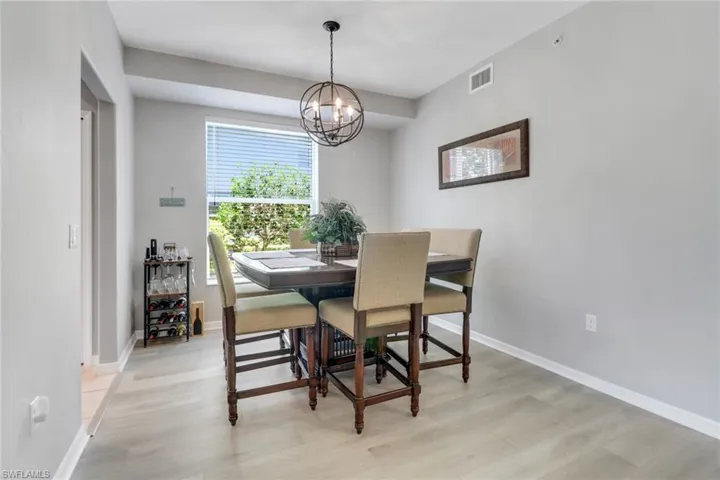 Dining space featuring light wood-style flooring and a chandelier