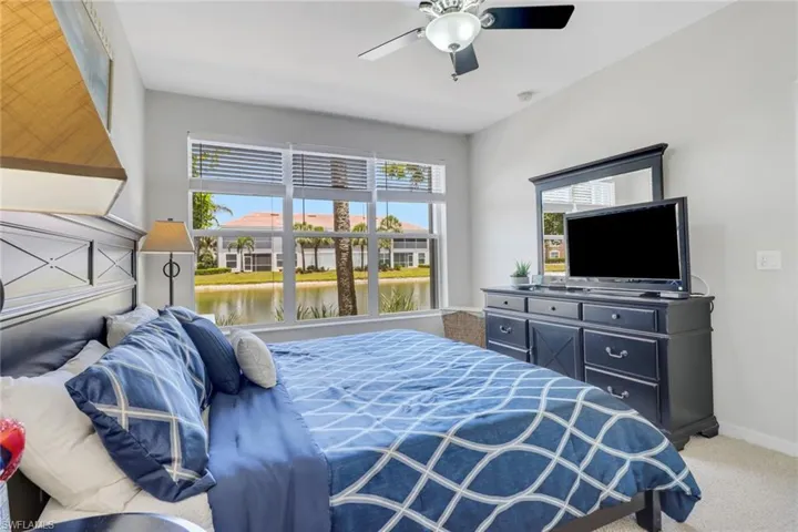 Carpeted bedroom featuring ceiling fan