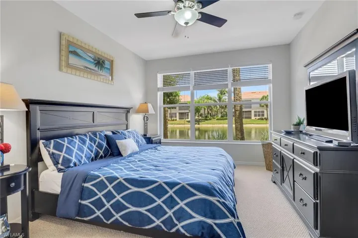 Bedroom featuring light colored carpet and a ceiling fan