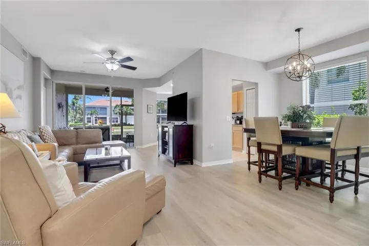 Living room featuring light wood-type flooring and a ceiling fan