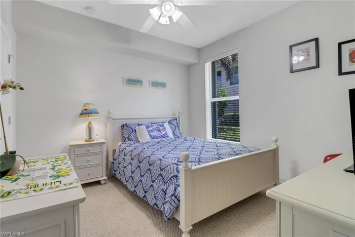 Bedroom featuring light colored carpet and ceiling fan