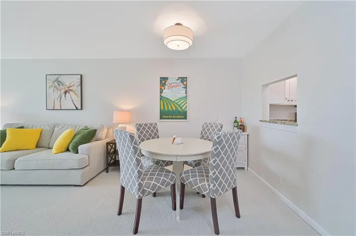 Dining area with a round table and upholstered chairs