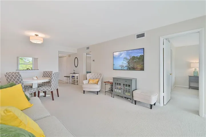 Bright living area featuring light-toned carpeting and neutral wall colors