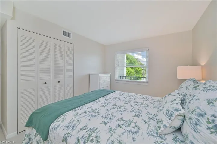 Interior room featuring louvered bi-fold closet doors, light-toned walls, and white trim