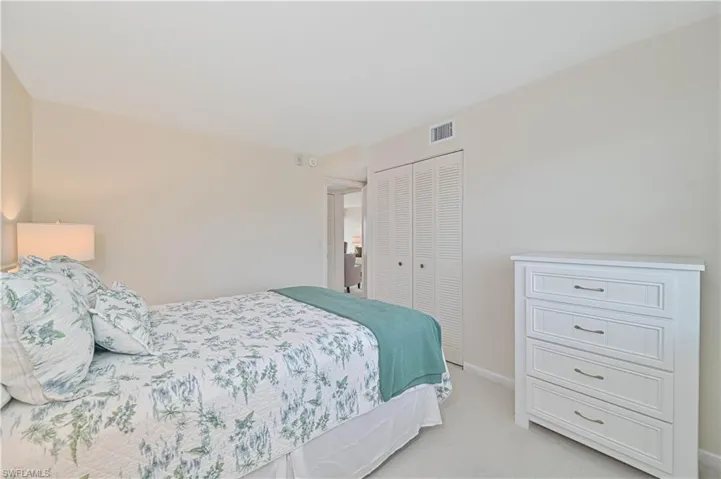 Neutral tone wall paint with white trim, louvered bi-fold closet doors, and recessed lighting