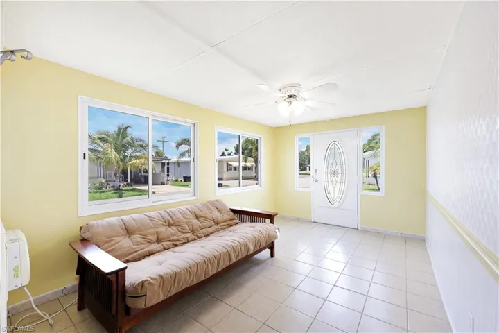 Sitting room featuring light tile patterned floors and ceiling fan