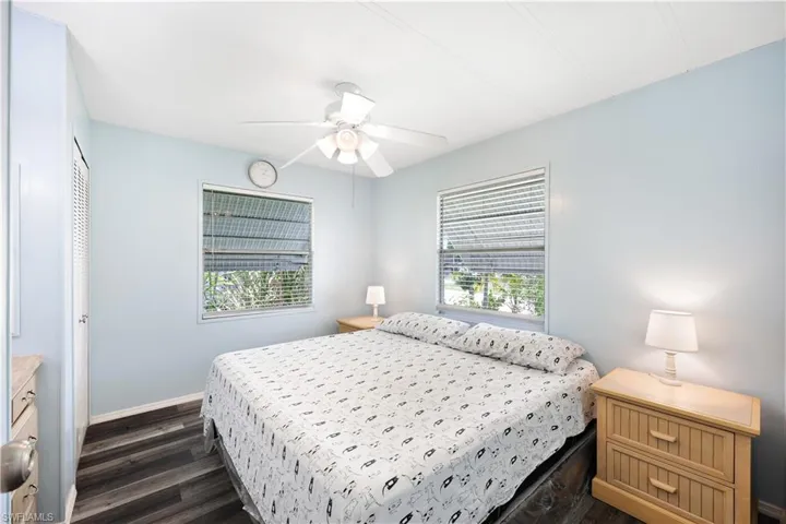 Bedroom featuring dark wood finished floors, a closet, and a ceiling fan