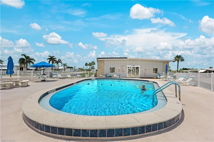 Community pool with a patio