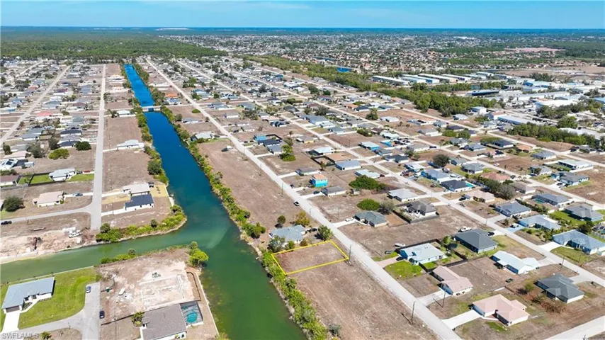 Aerial perspective of suburban area with a large body of water