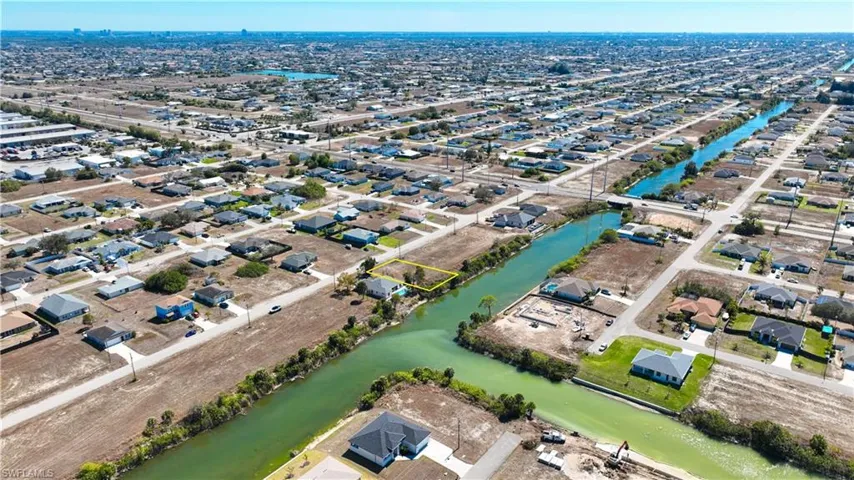 Aerial overview of property's location with nearby suburban area and a large body of water