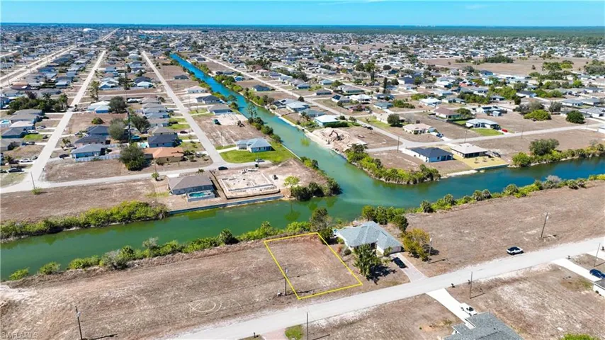 Aerial view of residential area featuring a nearby body of water