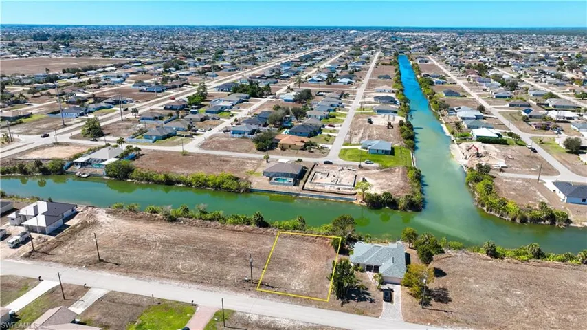 Aerial perspective of suburban area with a nearby body of water