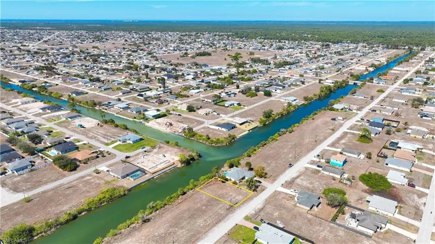 Aerial view of residential area featuring a large body of water