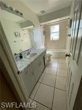 Full bathroom featuring vanity and light tile patterned floors