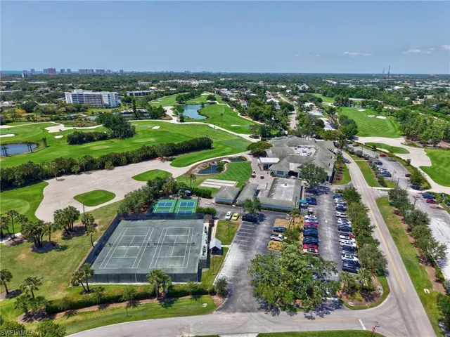 Drone / aerial view of a large body of water and a local golf course