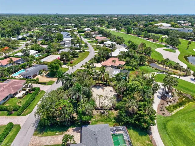 Aerial view of property's location featuring nearby suburban area and a golf course
