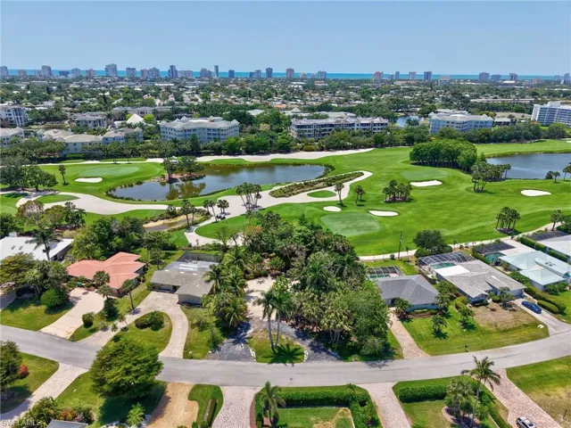 Bird's eye view of a view of skyline, a nearby body of water, and a golf club