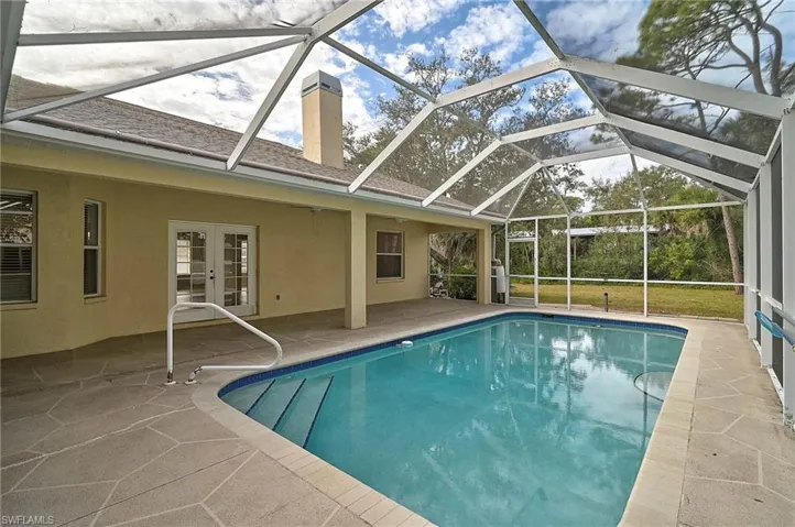 Outdoor pool featuring a patio area, and a french doors.
