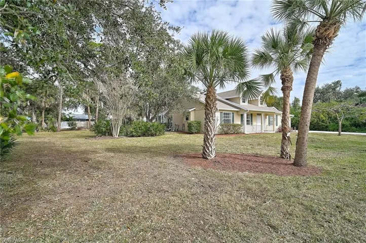 View of side facade with a front lawn
