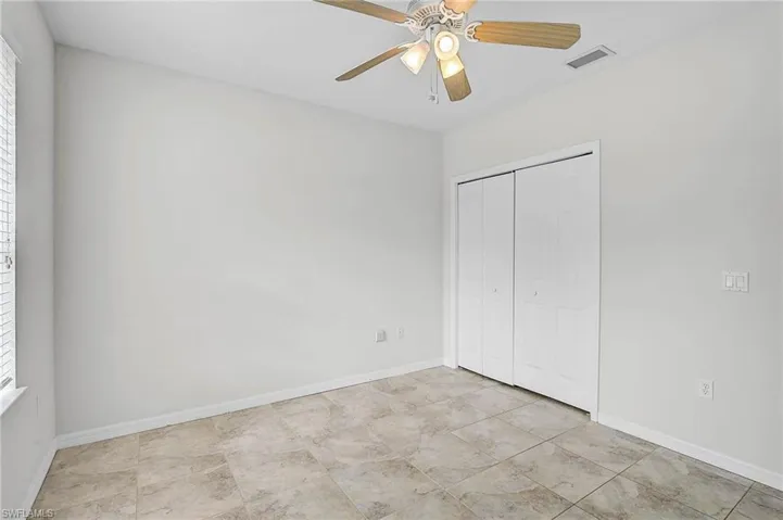 Bedroom 3 featuring a ceiling fan and a closet