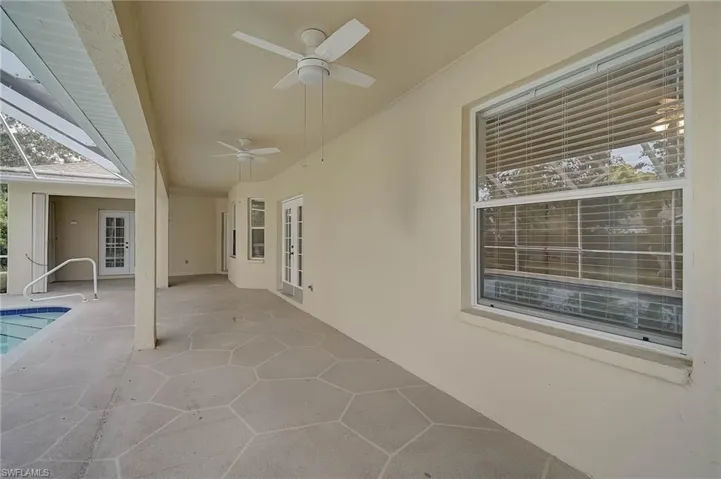 View of patio featuring a ceiling fan, a lanai, an outdoor pool, and a sunroom