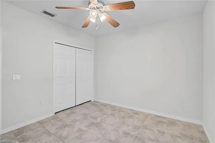 Bedroom 2 with a ceiling fan and a closet