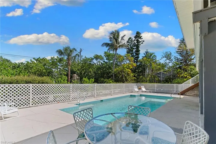 The property features a private swimming pool with a surrounding patio area, ideal for outdoor enjoyment