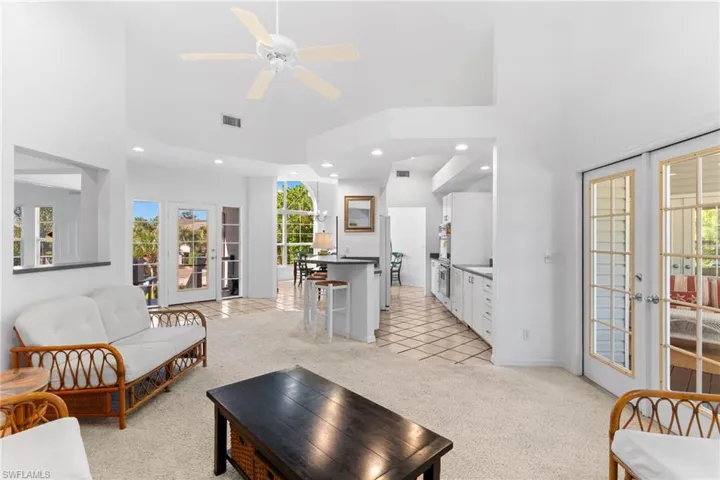 The property features an expansive open-concept living area with vaulted ceilings and recessed lighting