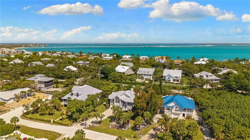 The property is situated within a vibrant coastal community, offering expansive views of the azure ocean and distant horizon