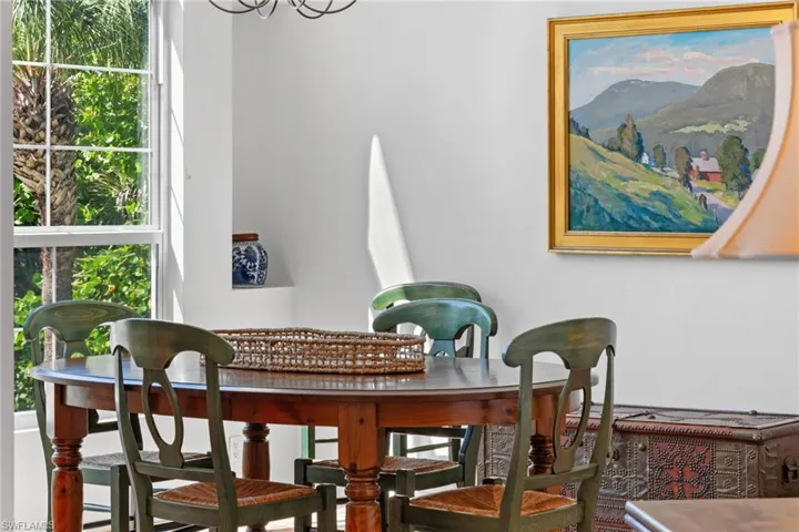 The property features a dining area with a window providing a view of green foliage