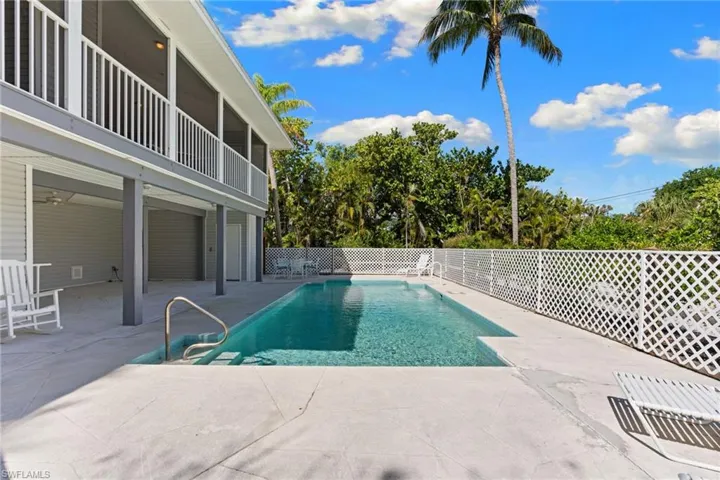 The property includes a private swimming pool with an integrated ladder, surrounded by a paved deck