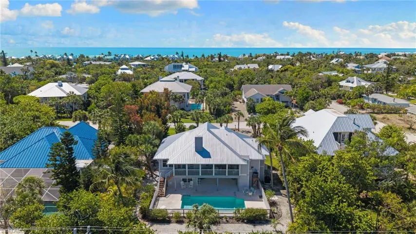 The property features an exterior with light-colored siding and a matching metal roof