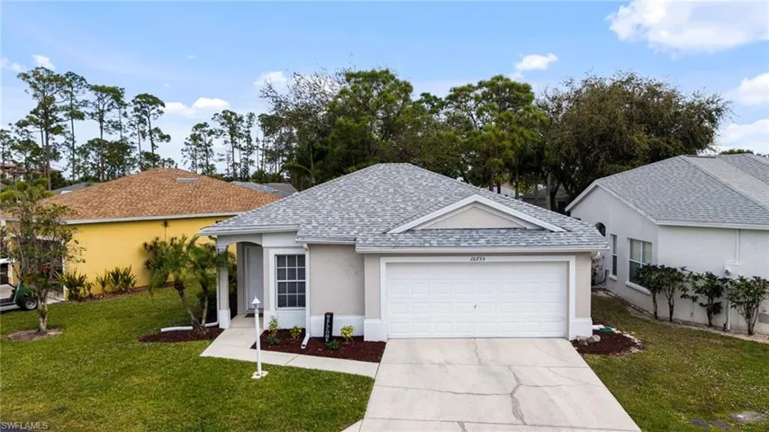 Single story home featuring a shingled roof, a front yard, a garage, and stucco siding